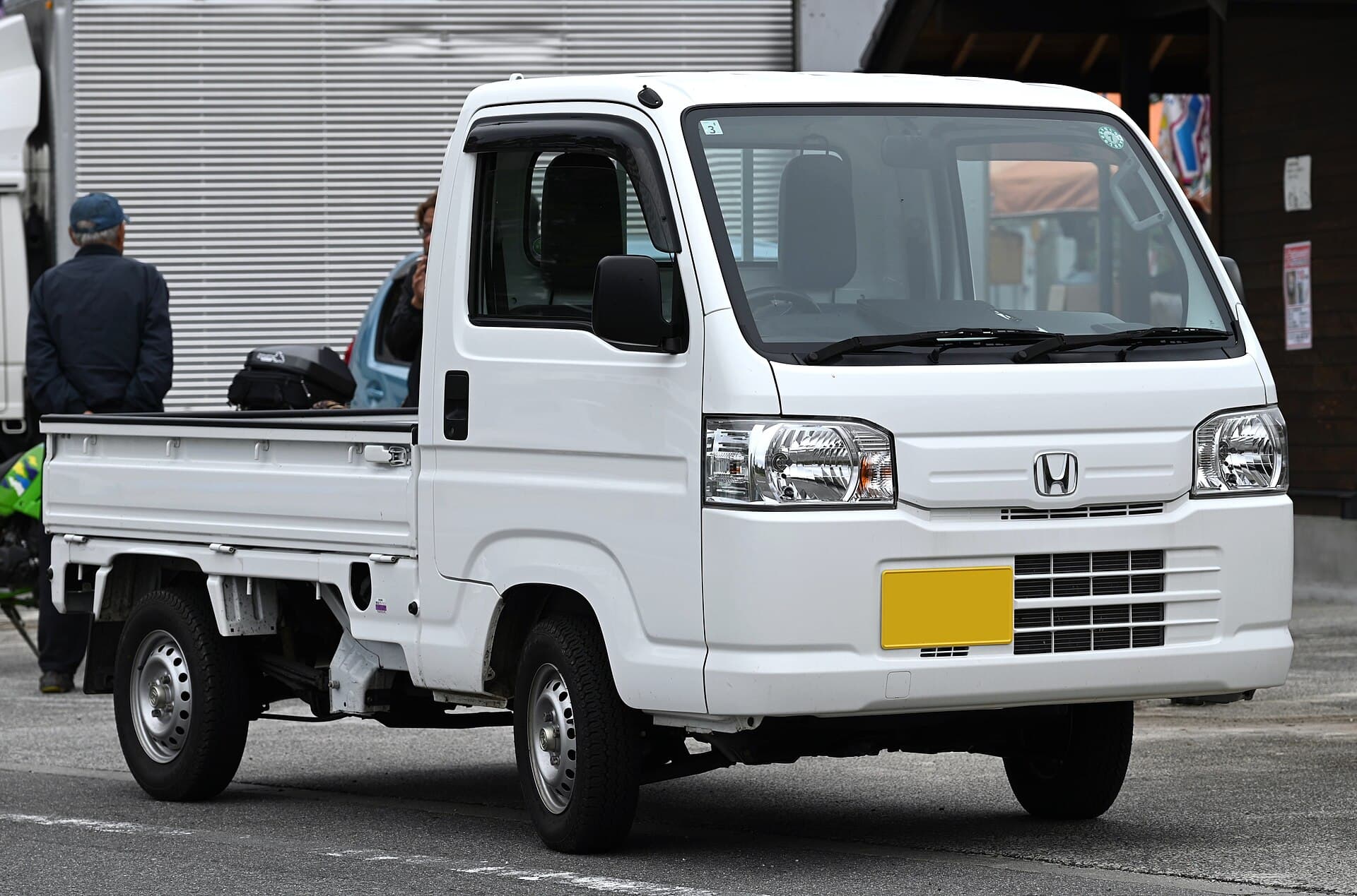 White Honda Acty kei truck, front three-quarter view
