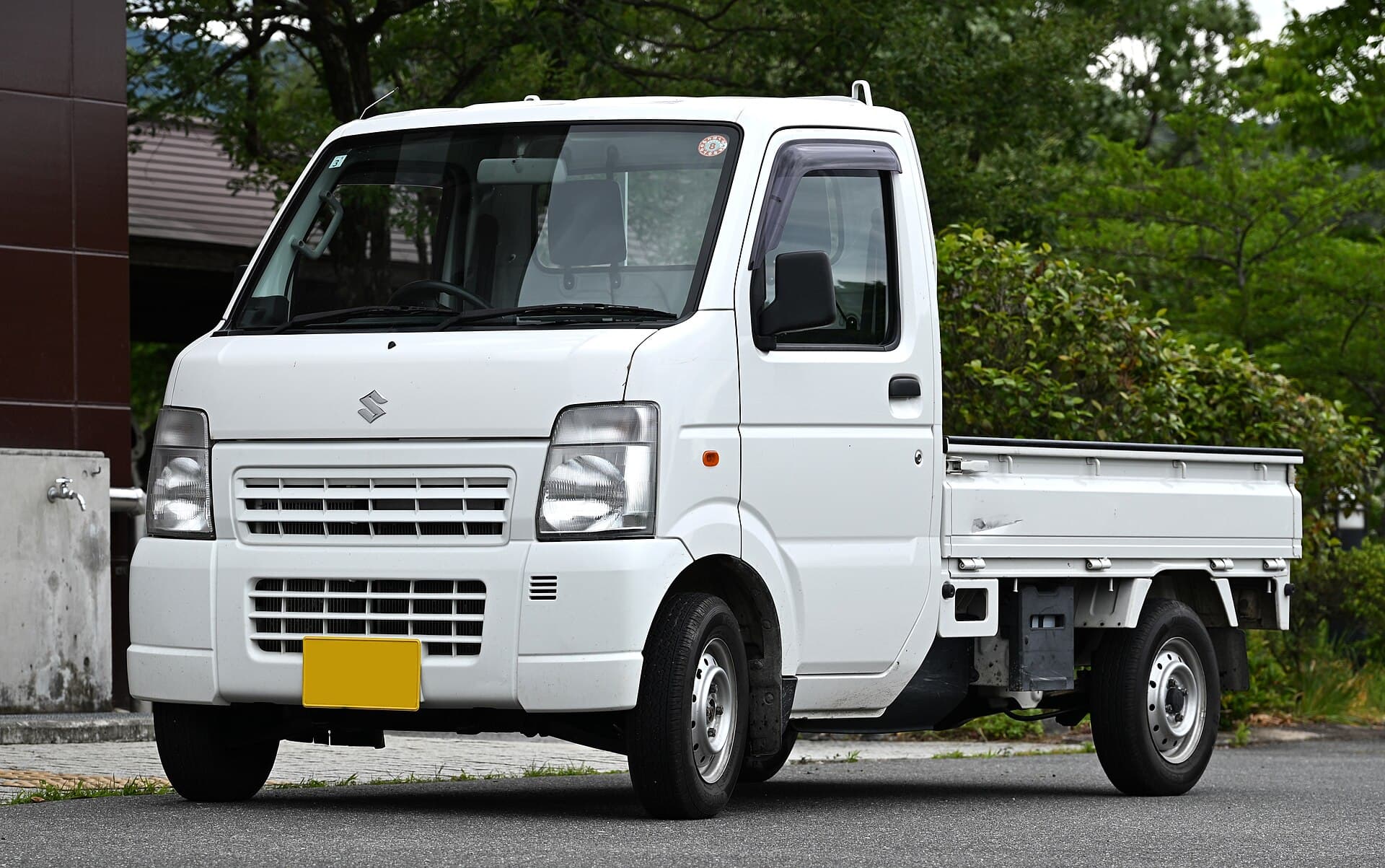 White Suzuki Carry kei truck, front three-quarter view