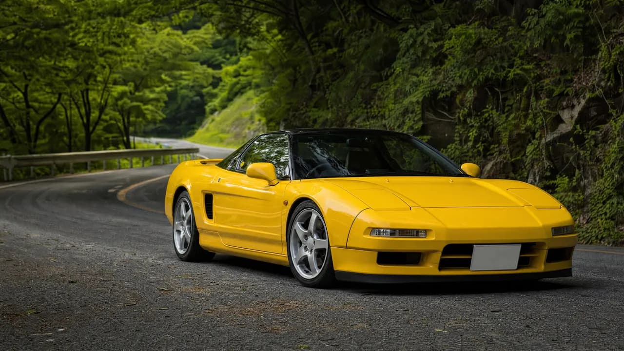 Yellow Honda NSX NA2 on a mountain road