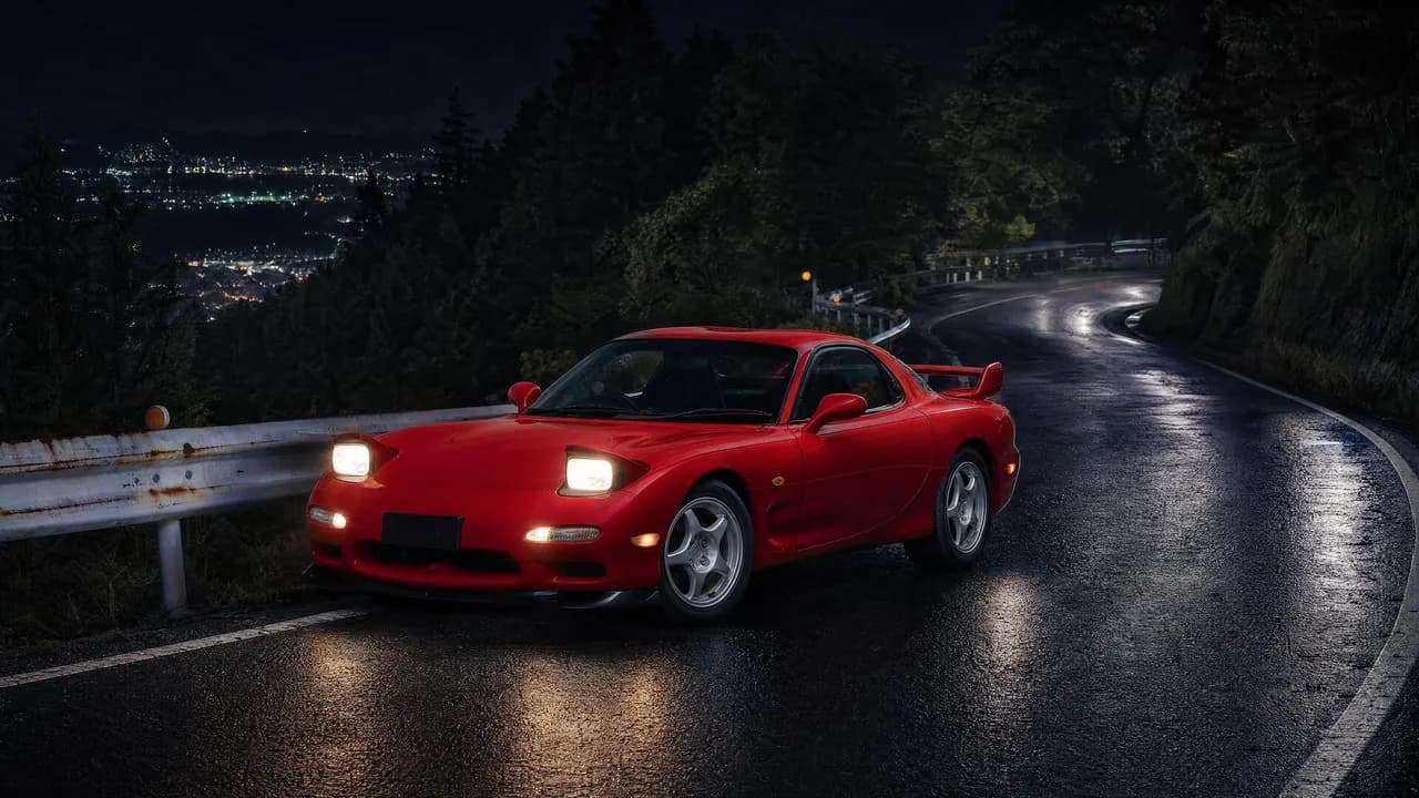 Red Mazda RX-7 FD on a mountain pass at night