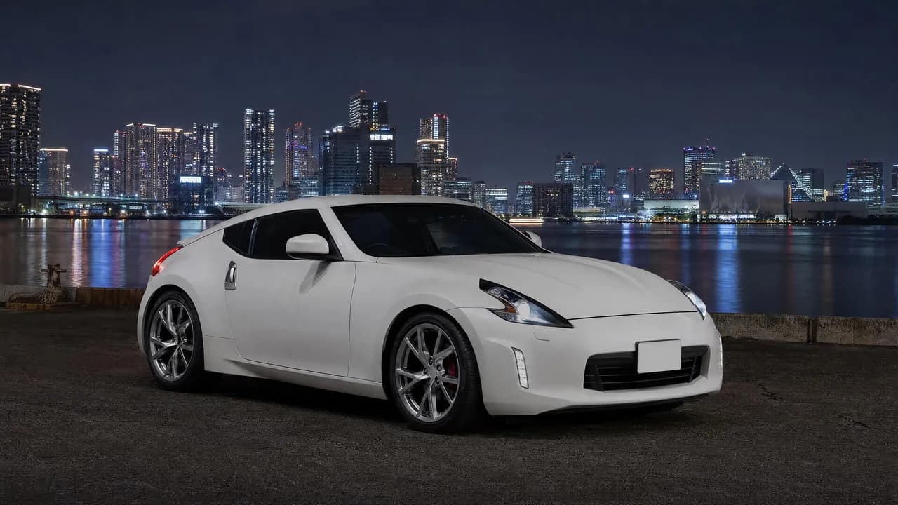 White Nissan 370Z by Tokyo Bay at night
