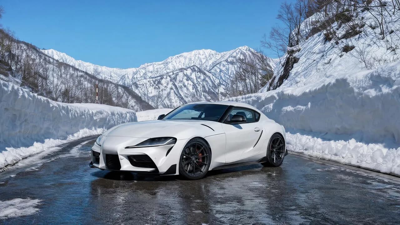 White Toyota Supra MK5 on a snowy mountain pass